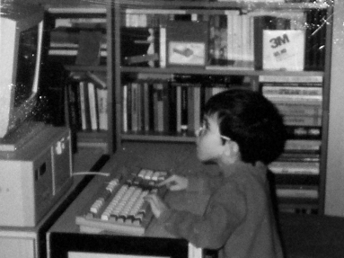 A black-and-white photo of me as a child, playing on the family’s oldest PC. The old mechanical keyboard forced me to press the spacebar with four fingers.