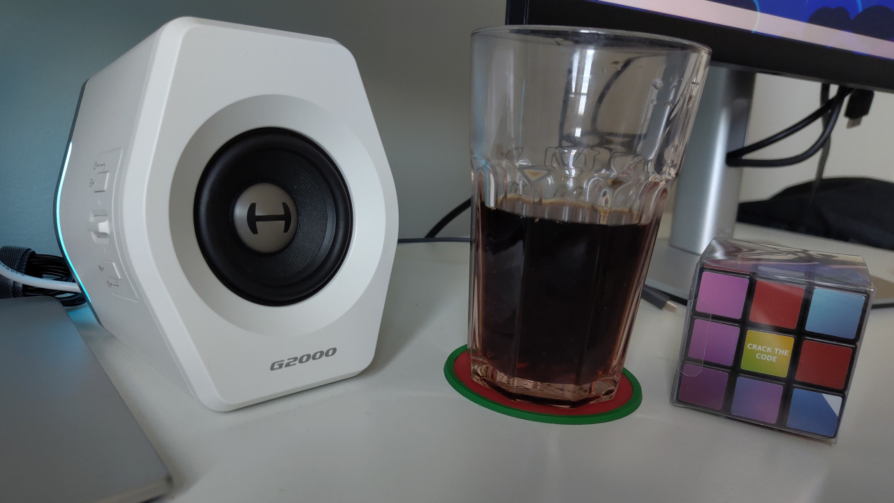 The right speaker with a glass of coke and Rubik's cube.