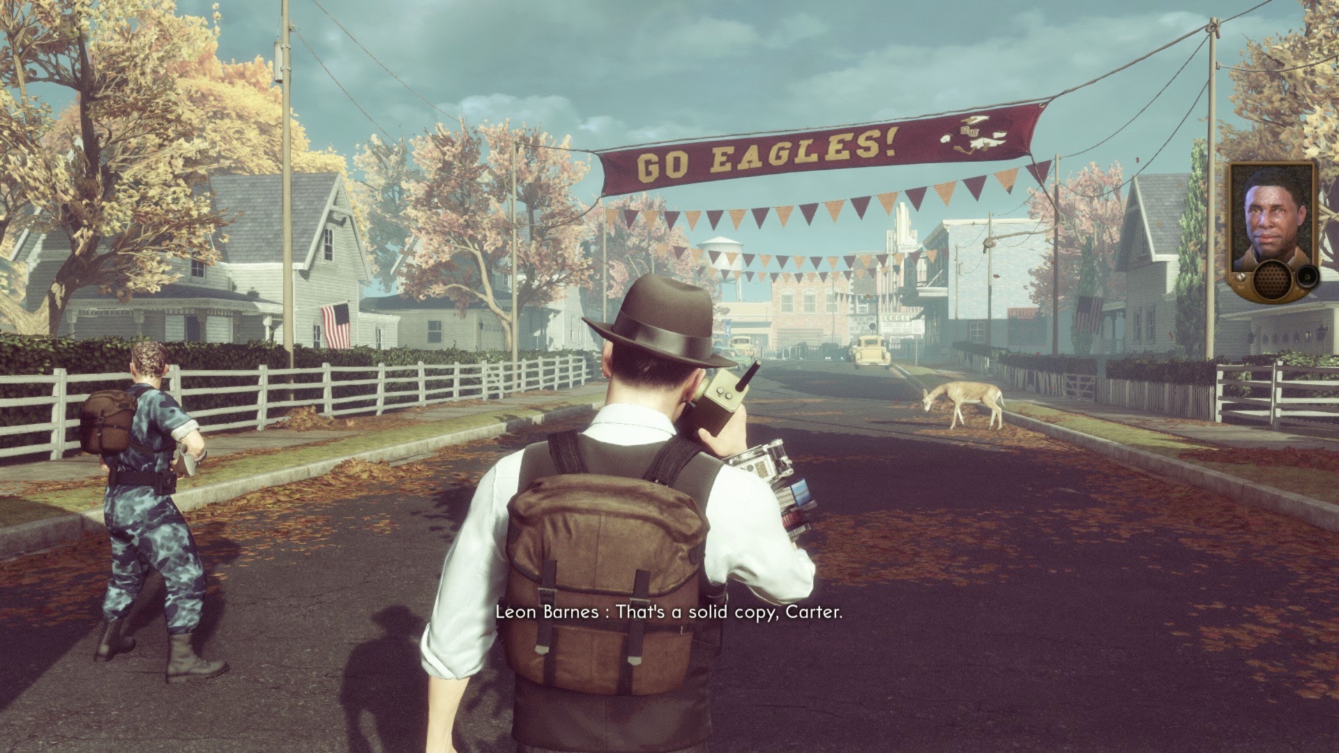 A street of a small American town from the sixties. A deer casually walks across the empty streets, hinting that the town became unusually calm in recent days. On the left, a man stands in army camouflage. In the center, an agent uses his radio. He wears a fedora, white shirt and dark brown vest.